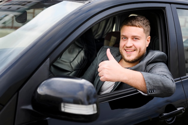 Cheerful young driver looking at the camera Photo | Free Download