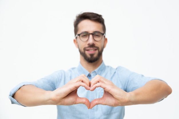 Free Photo Cheerful Young Man Showing Hand Heart Gesture