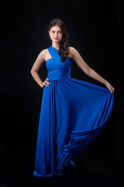 Premium Photo Cheerful Young Woman Wearing Blue Dress Standing And Posing