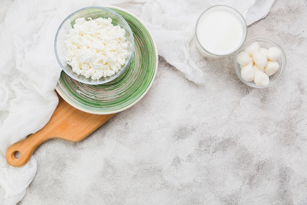 Can you freeze ricotta cheese? Bowl of ricotta on a wooden chopping board - top view