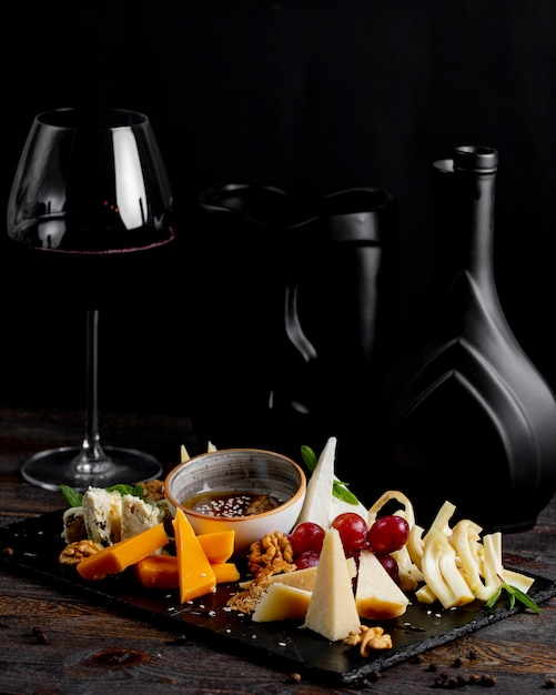 Free Photo | Cheese plate with glass of wine