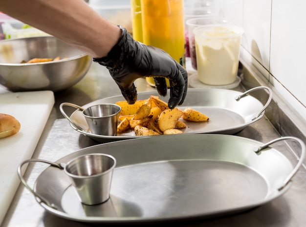 Premium Photo | Chef cooking french fries. restaurant.