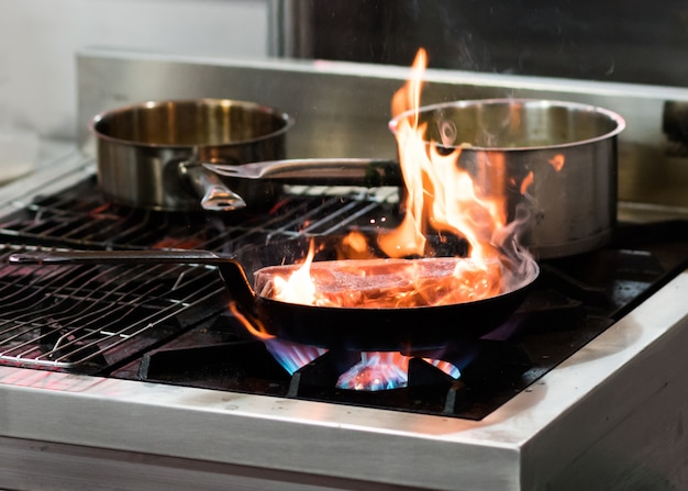 Premium Photo Chef Cooking With Flame In A Frying Pan On A Kitchen Stove 1959