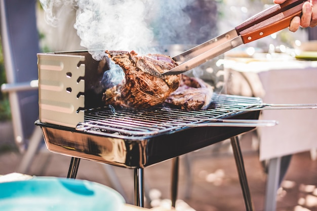 Chef Grill T Bone Steaks At Barbecue Dinner Outdoor Man Cooking Meat For A Family Bbq Meal Outside In Backyard Garden Premium Photo