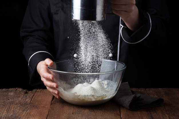 Chef hands pouring flour powder. | Premium Photo