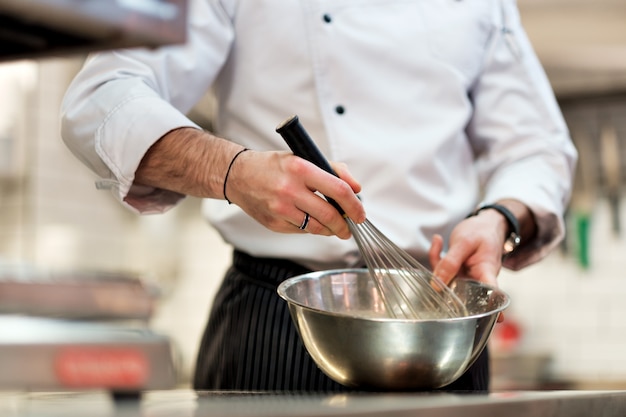 Premium Photo | Chef in hotel kitchen cooking