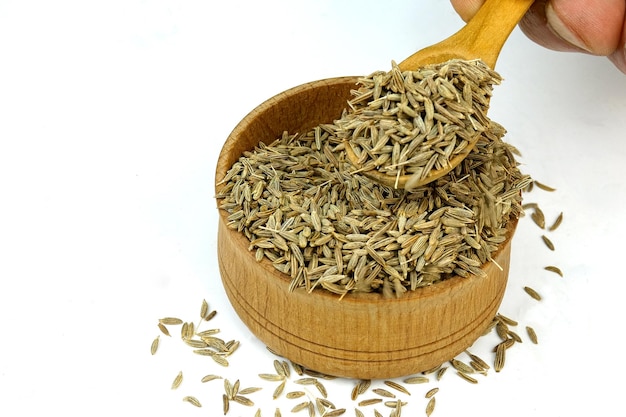 Premium Photo | Chef taking chopped dry cumin seeds or zira spices from ...