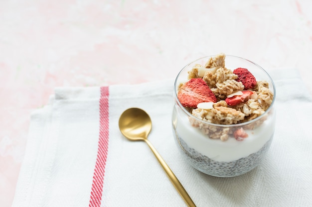 Chia pudding with almond milk, yogurt, and dried strawberries. Premium Photo