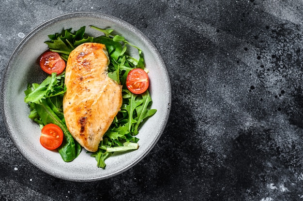 Premium Photo | Chicken breast fillet with arugula salad. healthy food ...