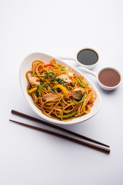 Premium Photo | Chicken hakka or schezwan noodles served in a bowl with ...