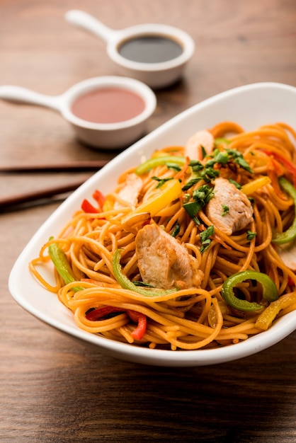 Premium Photo | Chicken hakka or schezwan noodles served in a bowl with ...