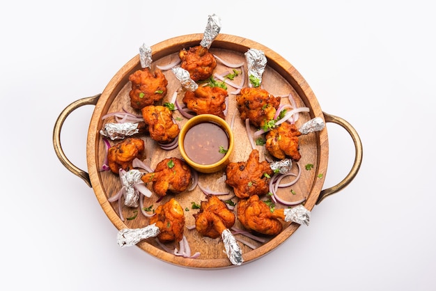 Premium Photo | Chicken lollipop is indian chinese appetizer which is a ...