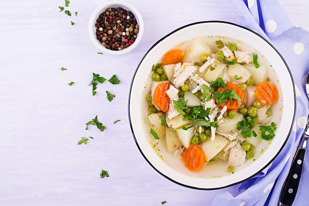 Premium Photo | Chicken soup with green peas, carrots and potatoes in a ...