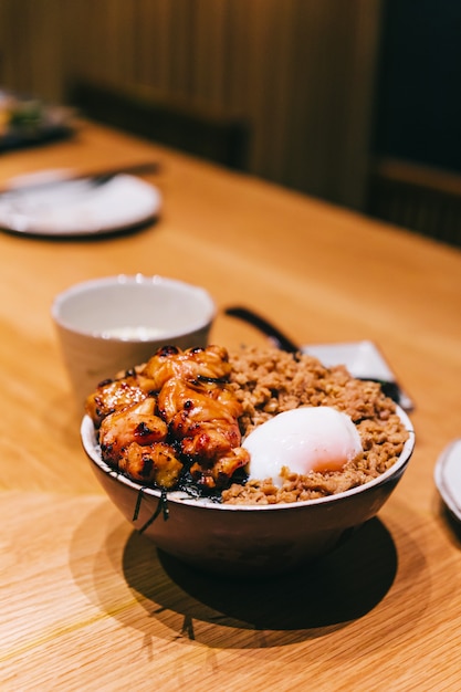 Premium Photo | Chicken yakitori rice bowl with minced pork served with ...