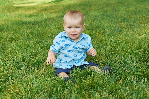 Premium Photo | Child boy on grass in park