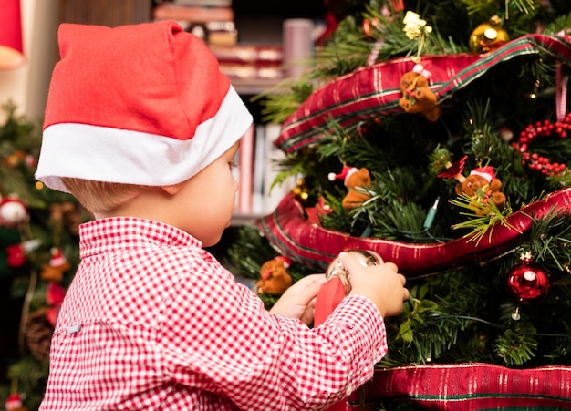 Free Photo | Child decorating the christmas tree