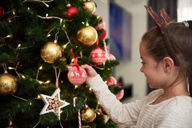 Free Photo | Child decorating the christmas tree