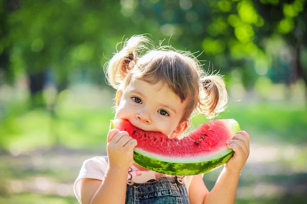 Premium Photo | A child eats watermelon. selective focus.