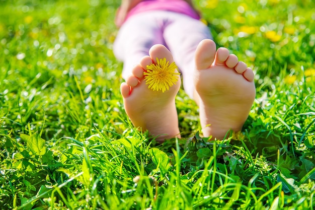 Premium Photo | Child feet on the grass