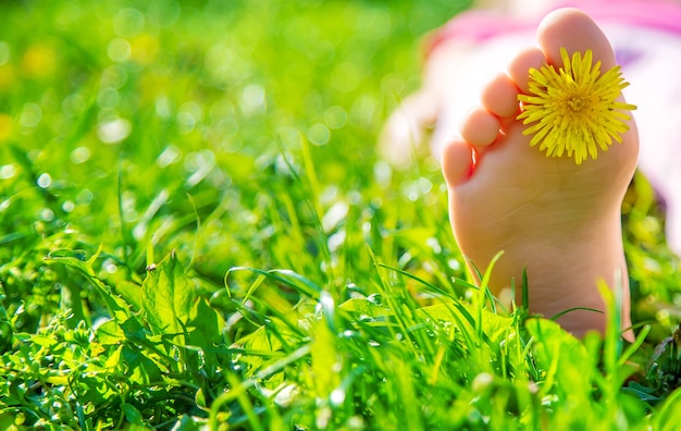 Premium Photo | Child feet on the grass