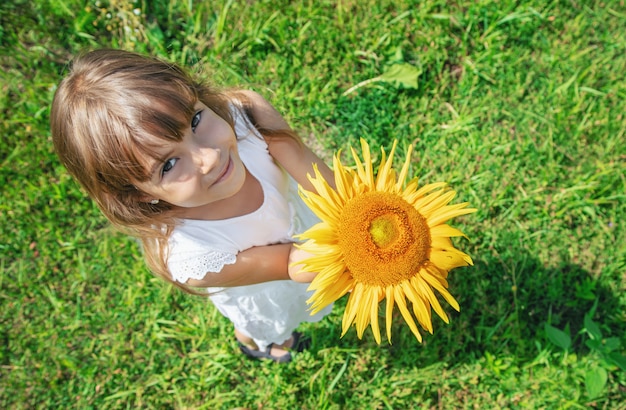 Premium Photo | A child in a field of sunflowers.