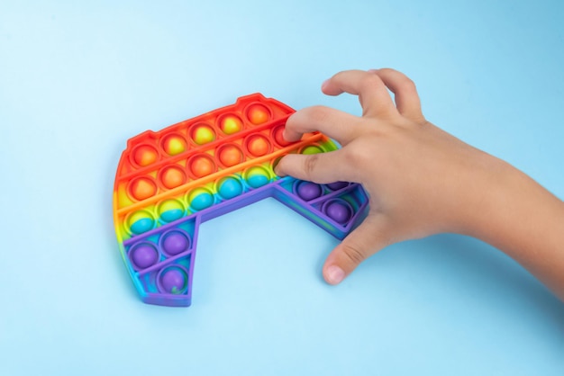 Free Photo | Child hand playing with pop it toy