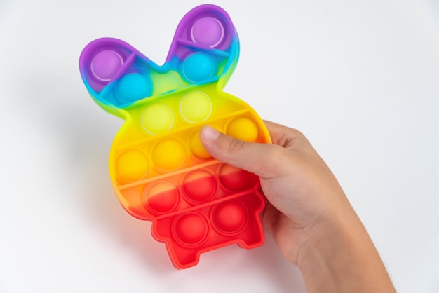 Free Photo | Child hand playing with pop it toy