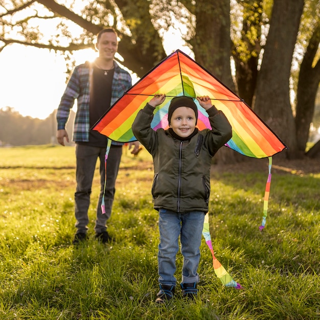 Free Photo | Child holding a kite above his head