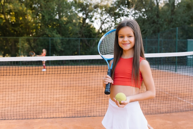 Premium Photo | Child playing tennis on outdoor court. little girl with ...