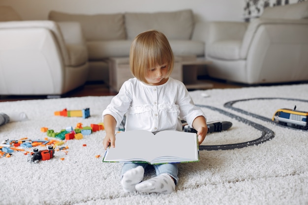 Child playing with book in a playing room Free Photo