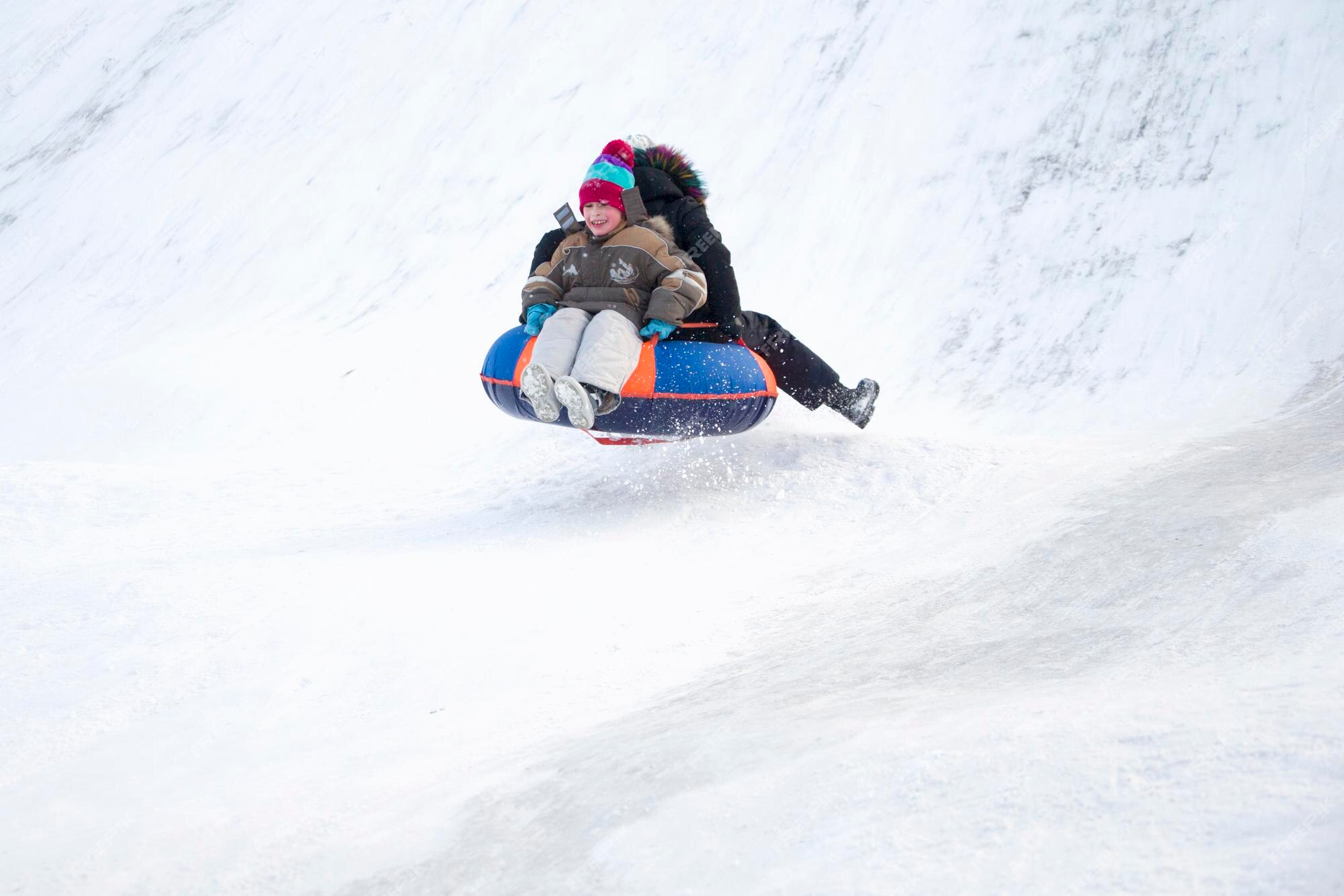 Premium Photo | Child sledding cheesecake.sledding off a snow slide.ski ...