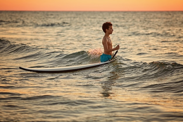 Premium Photo | Child surfing on tropical beach