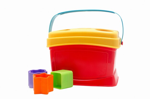 Premium Photo | Child toy red bucket and multi-colored molds. child sorter