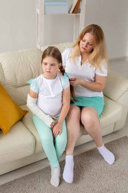 Premium Photo | Child with broken arm and gypsum spend time at home ...