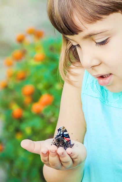 Premium Photo | Child with a butterfly. photo. nature.