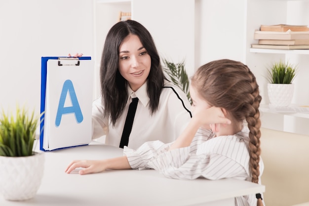 Premium Photo | Child with therapist working on pronunciation and ...