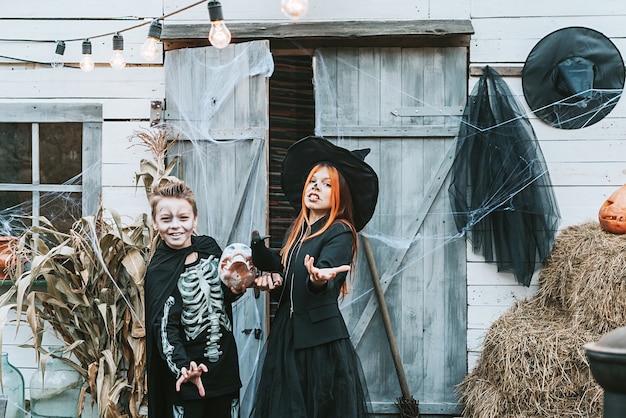 Premium Photo | Children a boy in a skeleton costume and a girl in a ...