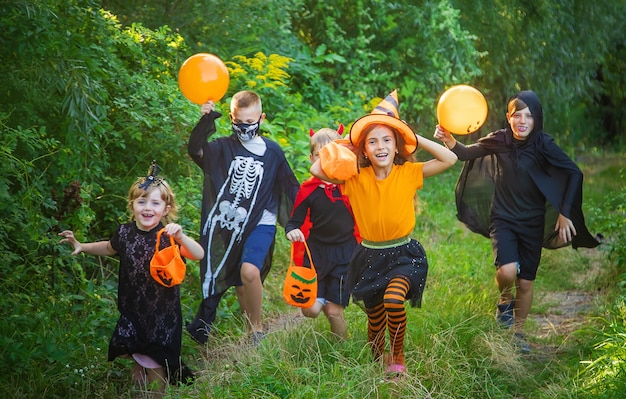 Premium Photo | Children celebrate halloween dressed up in costumes ...