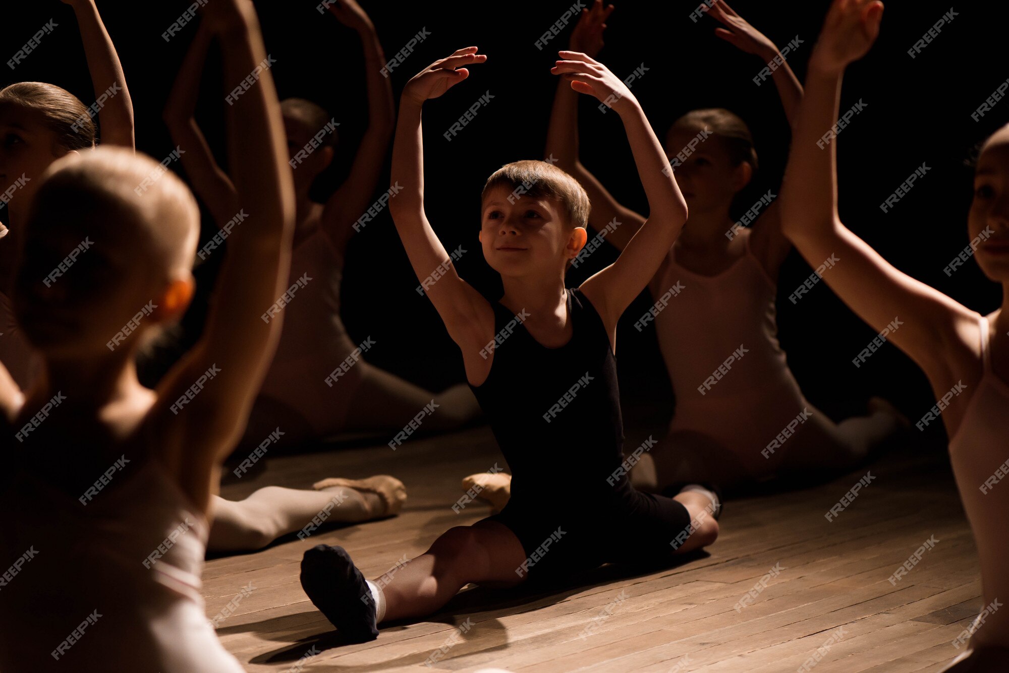 Premium Photo | Children doing splits while warming up on the stage