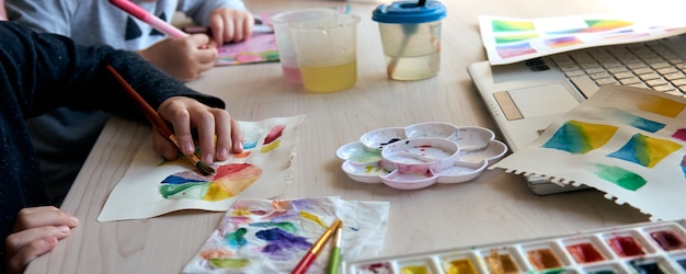 Premium Photo | Children Painting Pictures With Watercolor Paints During Art Lesson. Pupils Are Concentrating On Drawing With Brush. Watercolor Color Wheel And Palette. Color Theory Beginner Hobby Lessons