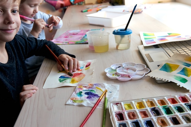 Premium Photo | Children Painting Pictures With Watercolor Paints During Art Lesson. Pupils Are Concentrating On Drawing With Brush. Watercolor Color Wheel And Palette. Color Theory Beginner Hobby Lessons