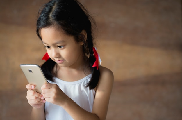 Premium Photo | Children playing the phone