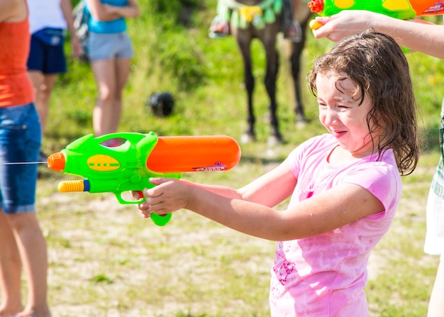 Premium Photo | Children playing water battle water game battle