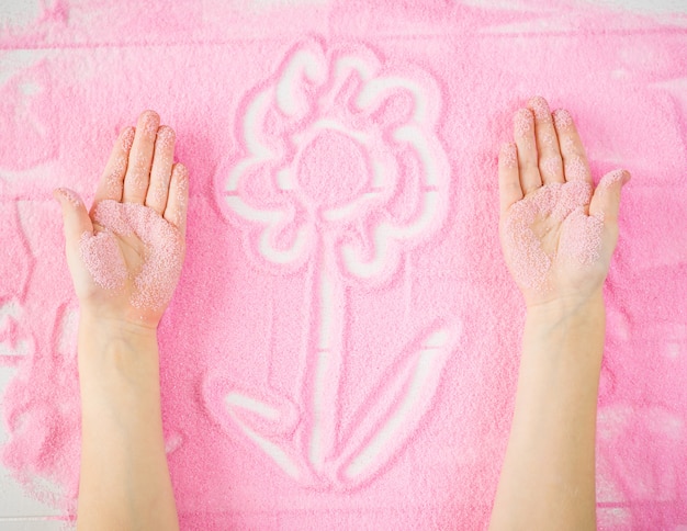 Children S Hands Make A Decorative Flower On The Sand Premium Photo