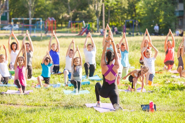 Premium Photo Children Do Yoga With An Outdoor Trainer