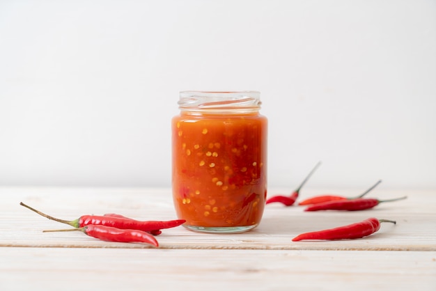 Download Premium Photo Chilli Or Chilli Sauce In Bottle And Jar On Wood