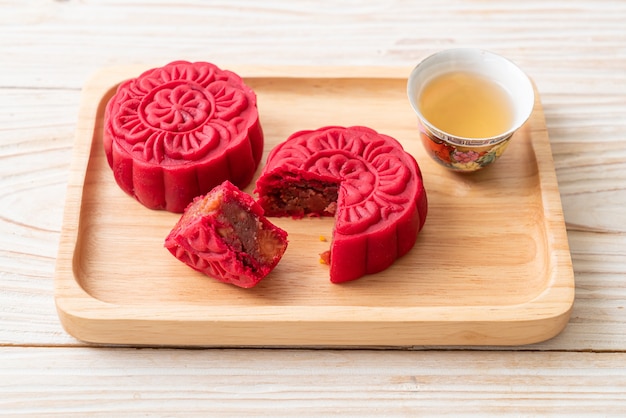 Premium Photo Chinese Moon Cake Strawberry Red Bean Flavour On Wood Plate