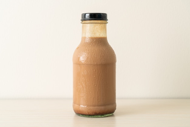 Premium Photo | Chocolate milk in glass bottle on table