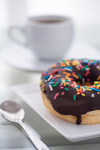 Download Premium Photo Chocolate Sprinkles Donut On A White Plate And A Cup Of Coffee On A Light