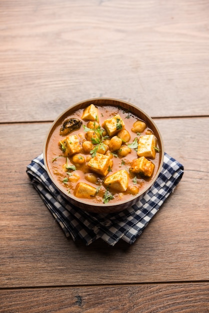 Premium Photo | Chole paneer curry made using boiled chickpea with ...